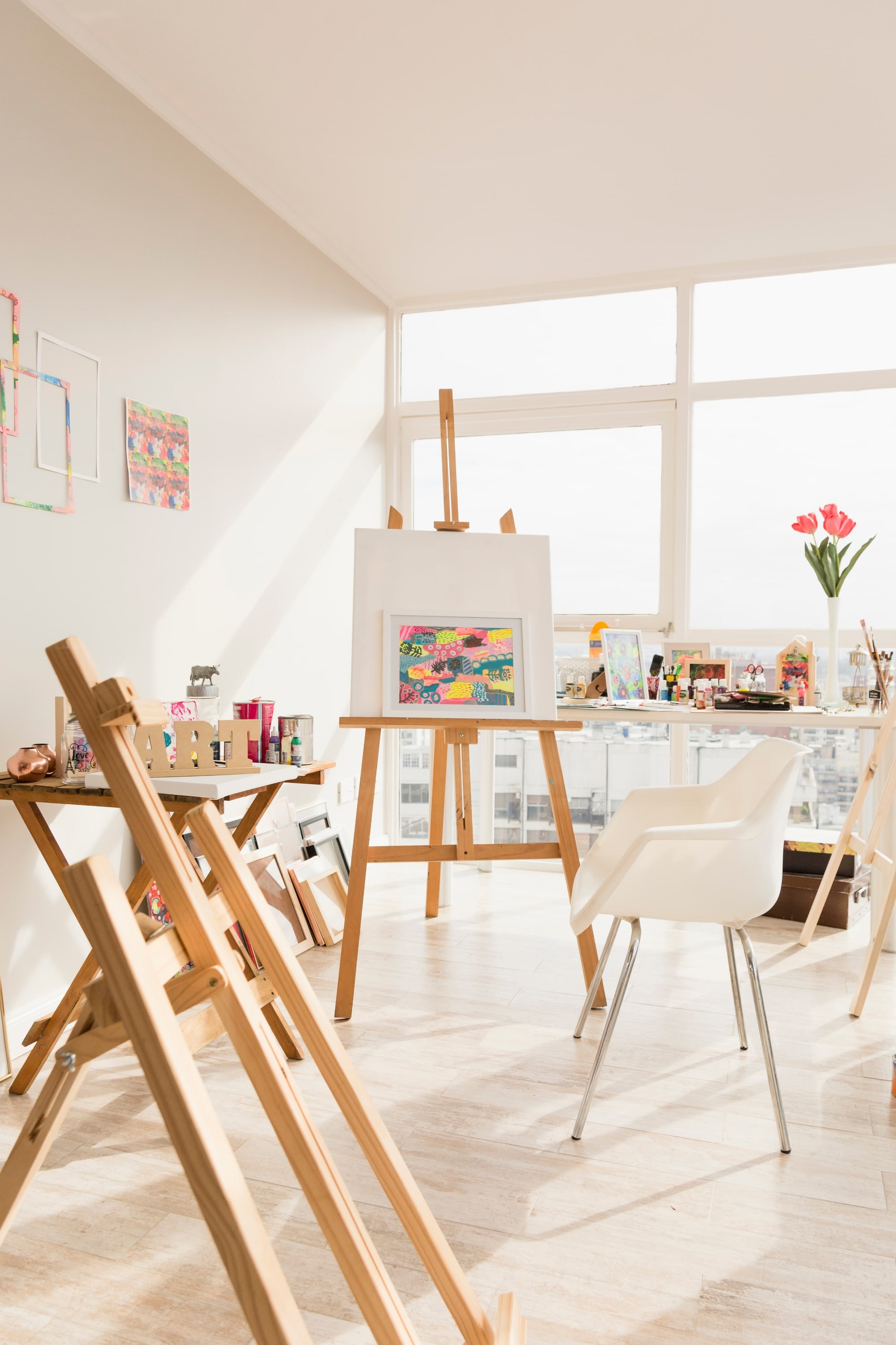 Bright creative studio with easels and natural daylight