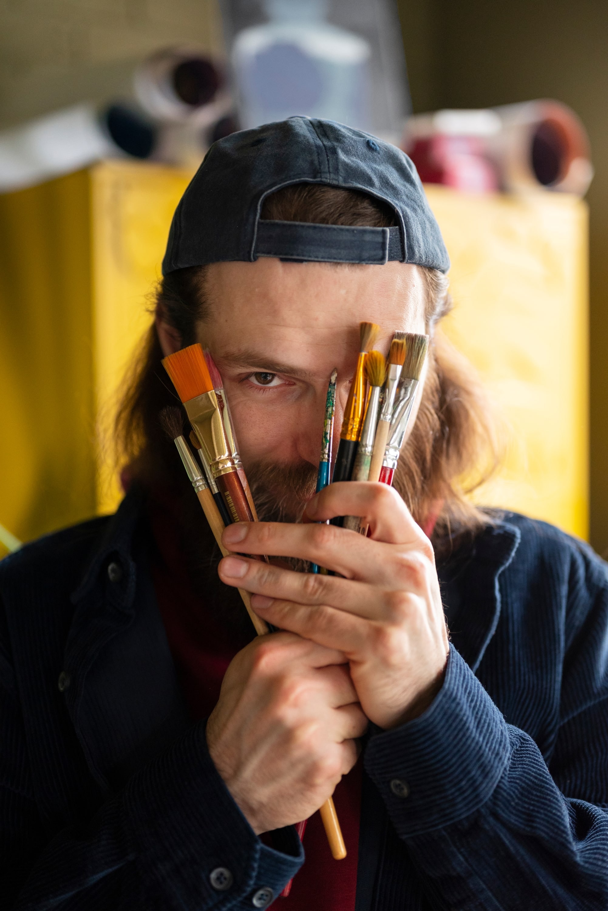 Artist holding paint brushes